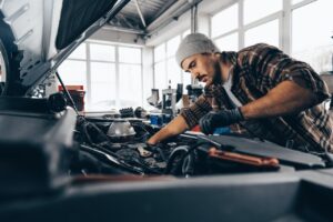 mechanic-examining-car-in-auto-car-repair-service-center.jpg