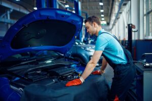 smiling-worker-checks-vehicle-car-service-station.jpg